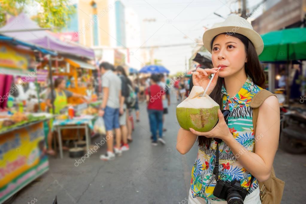 young student drinking fresh coconut water