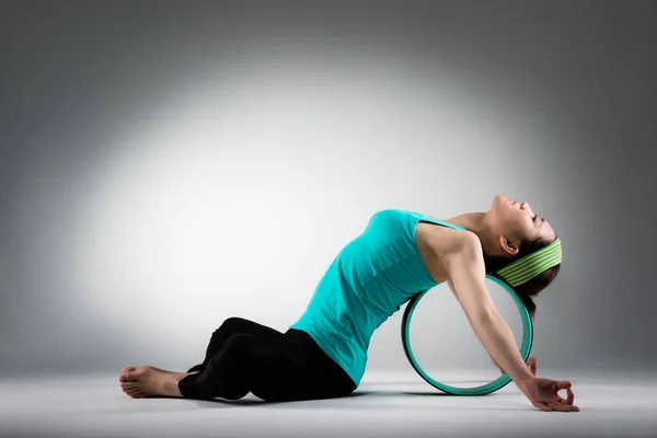 Elegant female gym player lying on pilates ring — Stock Photo, Image