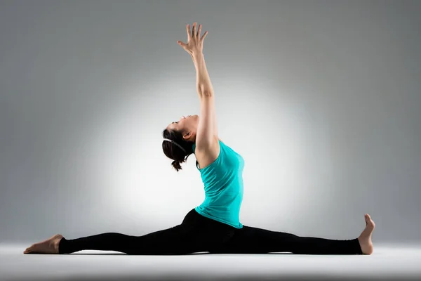 Yoga student split her legs and hands up — Stock Photo, Image