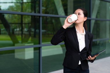 bilgisayar tutarak sıcak kahve içme Bayan takım elbise