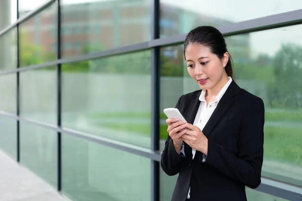 Elegant office worker girl using mobile cell phone — Stock Photo, Image