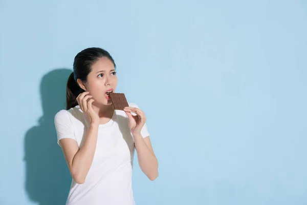 stock image attractive lady standing in blue wall background