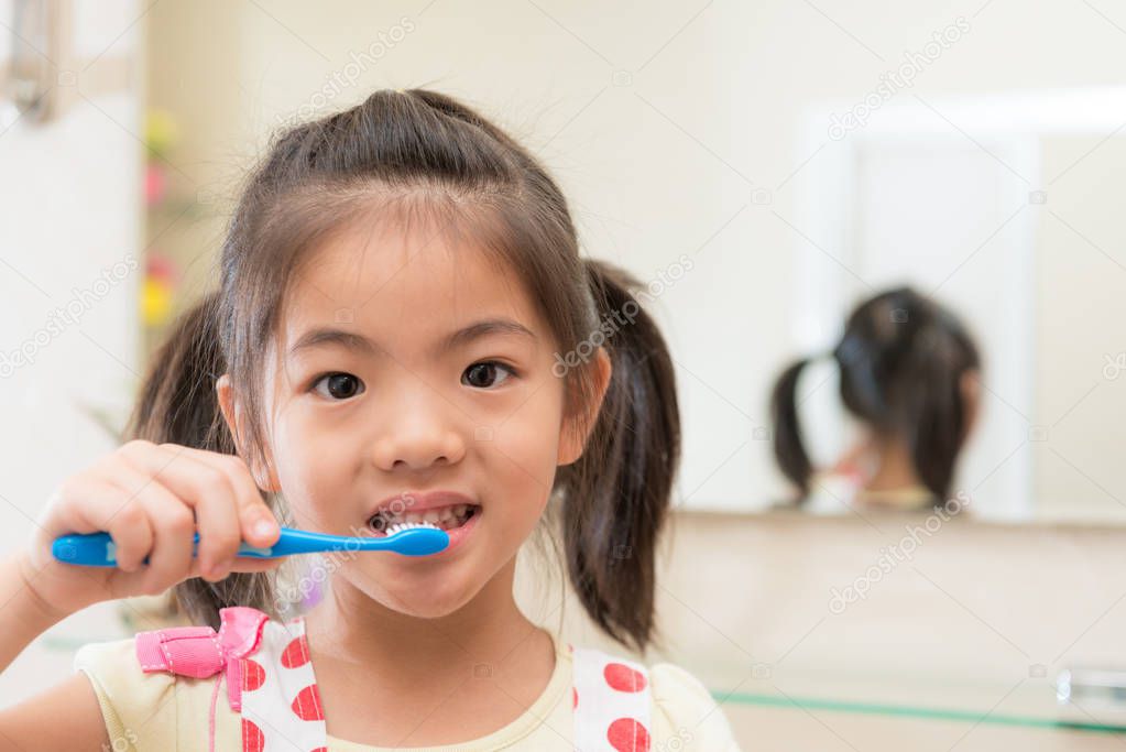smiling lovely children girl using toothbrush