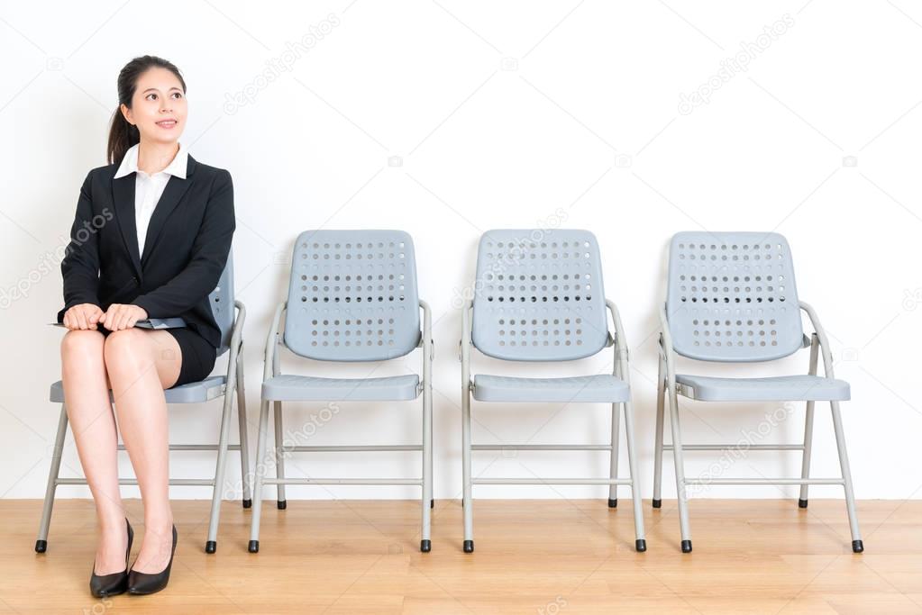 fresh graduate lady sitting on wood floor chair 
