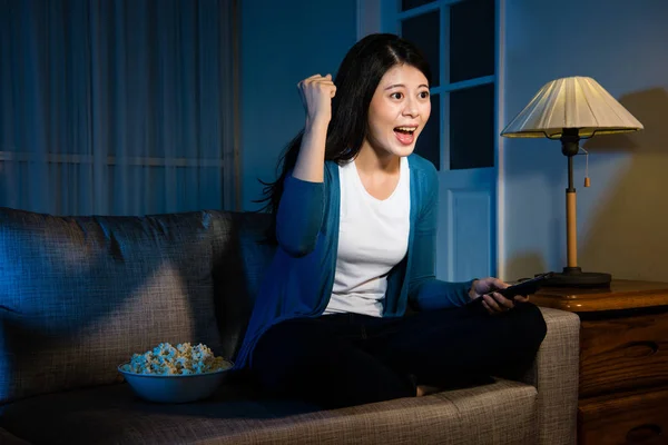 smiling woman watching football game championship