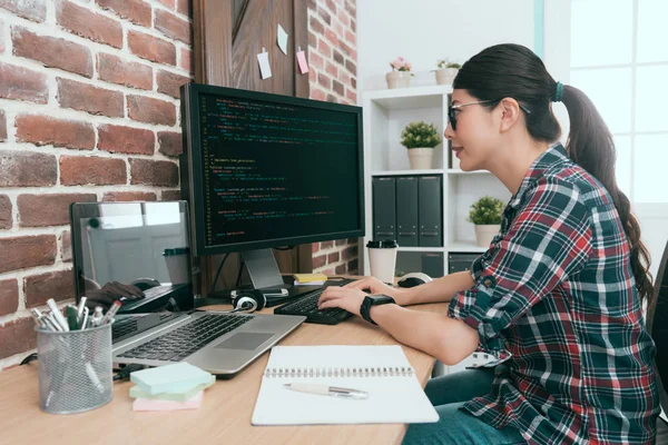 beauty smiling female programmer using computer