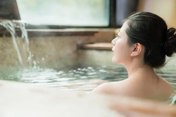 Charming girl stay in hot spring water — Stock Photo, Image