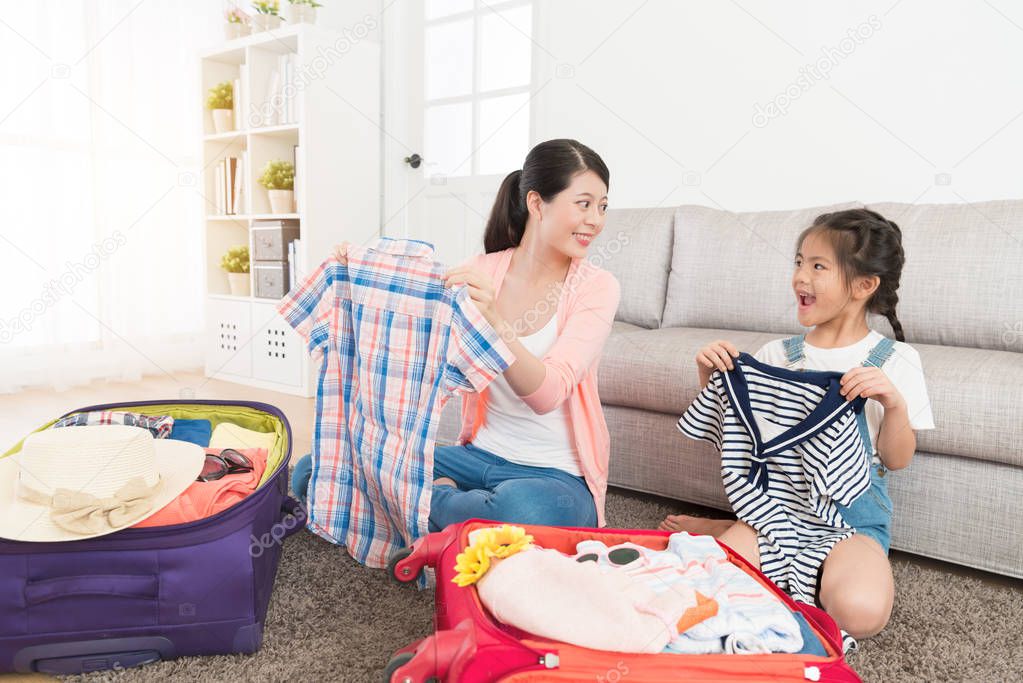 woman with cute girl organize personal clothing