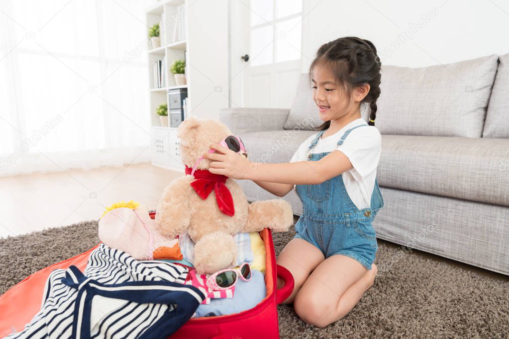 pretty little girl packing luggage suitcase