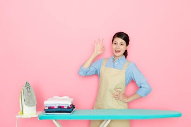 confident female housekeeper showing ok gesture clipart