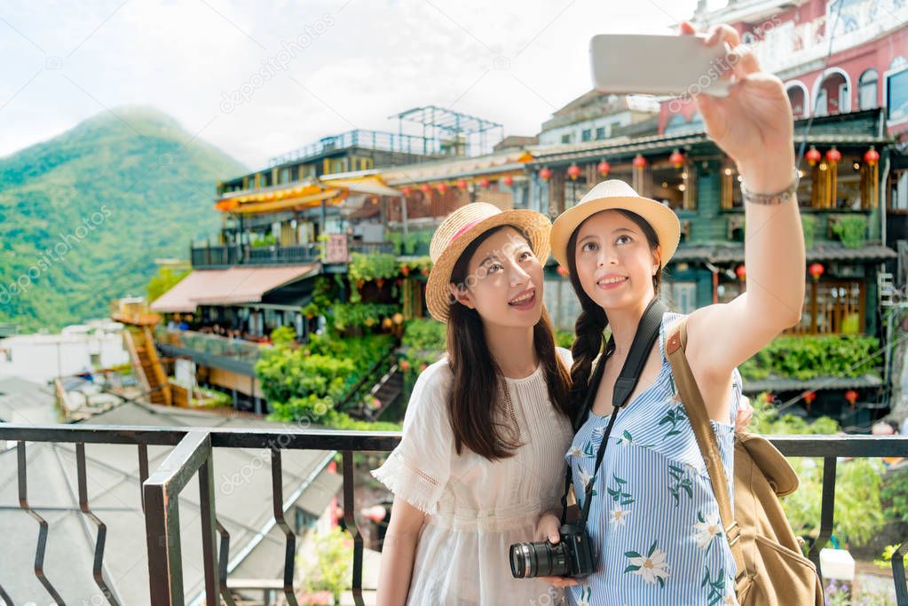 girls taking selfie of famous landmarks 