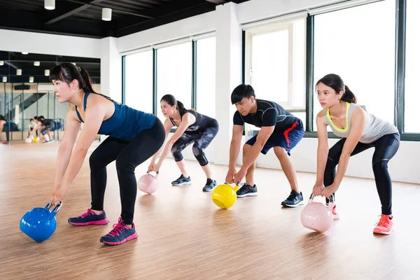 team of fitness player exercise with kettlebell