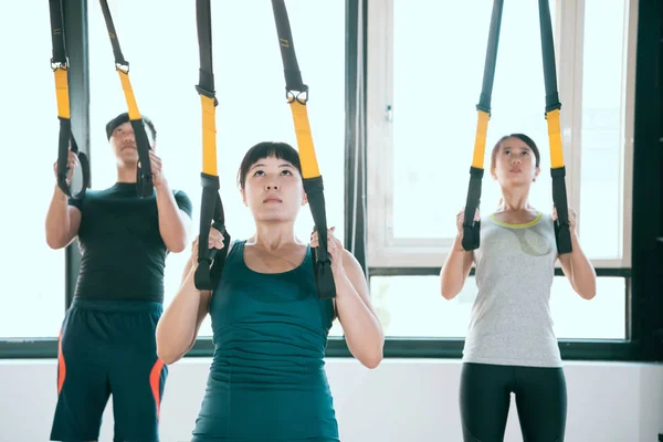 Professional expert TRX pulls up and looks up — Stock Photo, Image