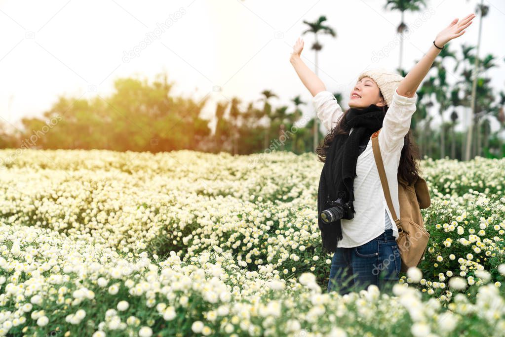 Woman enjoy the fresh air in the daisy field