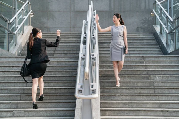 businesswoman greet on stairs