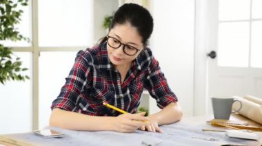 Güzel Çinli kadın tasarımcı mühendis ve cep telefonu saat resepsiyon süre yaratıcı office Studio hata olmadan daha hızlı iş Asya yüz. Meslek ve iş işgal kavramı.