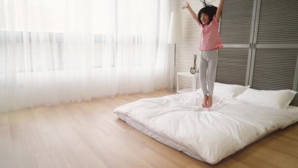 Little Asian Girl Cheer Coming Holiday She Excited Jumping Bed — Stock Video