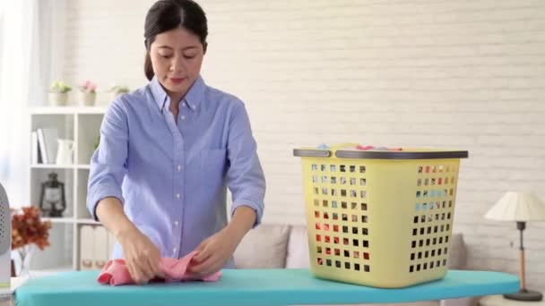 Woman holding a basket of clean clothes going to the living room to prepare for ironing, housewife doing housework concept — Stock Footage Woman Holding Basket Clean Clothes Going Living Room Prepare Ironing Video Clip