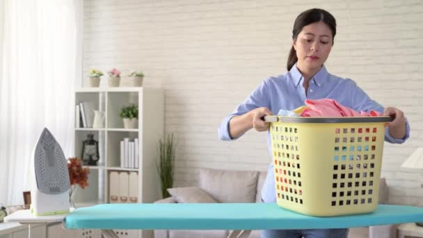Beauty elegant housewife walking to the living room and ironing all family clothing to solving clothes wrinkle problem. — Stock Footage Beauty Elegant Housewife Walking Living Room Ironing All Family Clothing Royalty Free Stock Footage