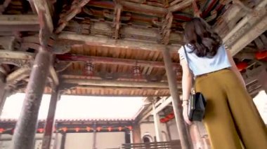 Asyalı kadın Longshan tapınakta duran ve eski bina tavana bakarak görünümünü.
