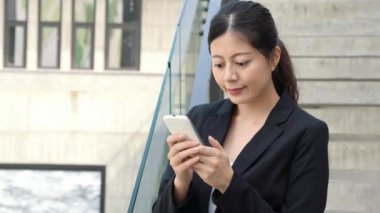 Çekici kadın manifatura mesaj patronu bir dostu gülümsemek ayakta açık havada siyah bir takım elbise ile.