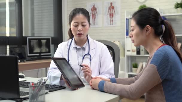 Asian Female Doctor Showing Ray Photo Digital Tablet She Holds — Stock Video