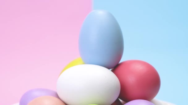 Heap Coloured Eggs Rotating Blue One Top Punchy Pastel Background — Stock Video