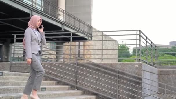 Young Beautiful Asian Muslim Businesswoman Using Smartphone While Walking Stairs — Stock Video