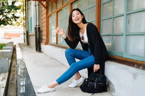 Woman leaning on wooden window of old house — 스톡 사진