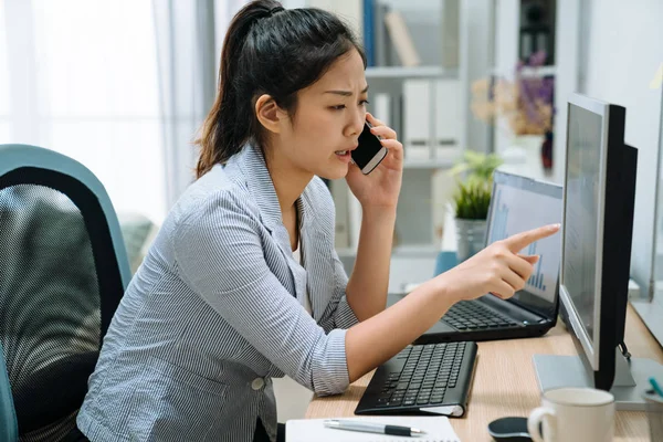 Employee work on computer talking on mobile phone — 스톡 사진