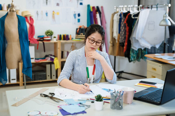 designer drawing seasonal collection on sketch