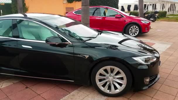 Menton, Francie - 3. března 2018:-luxusní černé Tesla Model S a červená elektromobily Tesla Model X zaparkoval na náměstí v Mentonu na francouzské Riviéře – 4 k Video
