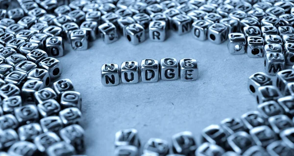 파란색 표면에 큐브로 Nudge — 스톡 사진