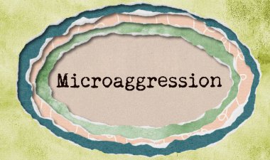 Microaggression - typewritten word in ragged paper hole background - concept tattered illustration clipart