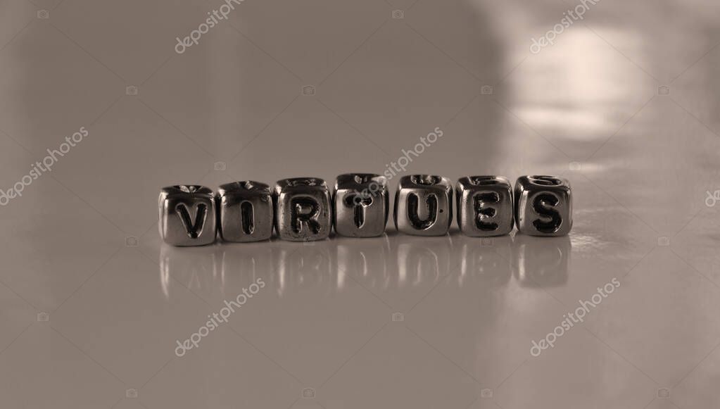 Virtues - moral excellence -  word from metal blocks - concept sepia tone photo on shine background