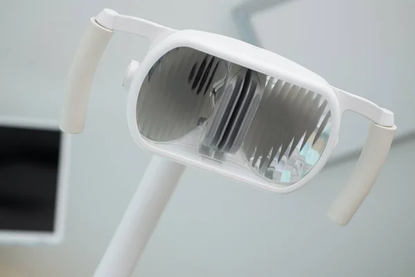 Stomatologicznych opieki zdrowotnej koncepcja tło - Dental uchwyt lampy z bliska. — Zdjęcie stockowe