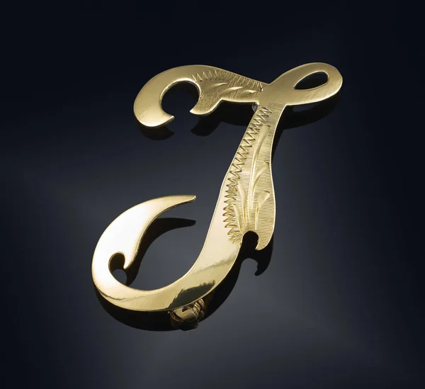 Golden brooch isolated on black — Stock Photo, Image