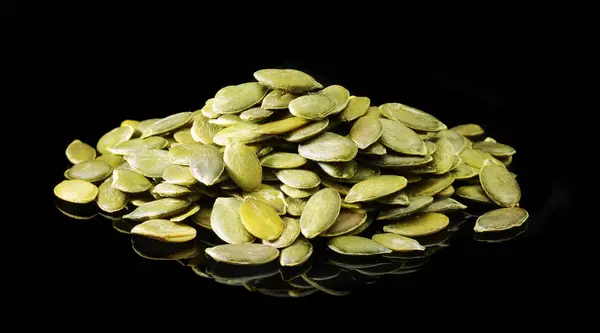 Raw Organic Pumpkin Seeds isolated on black background — Stock Photo, Image