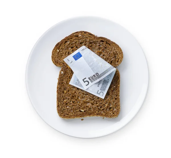 Rebanada de pan con billetes europeos en plato blanco — Foto de Stock
