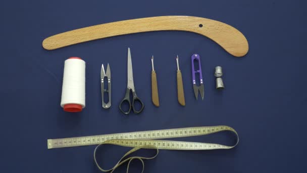 Flat lay. Color fabric, scissors, a curl, buttons, threads are visible. — Stock Video
