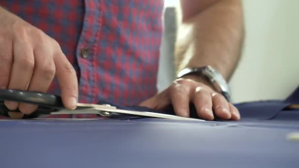 A tailor in a sewing workshop at work. — Stock Video