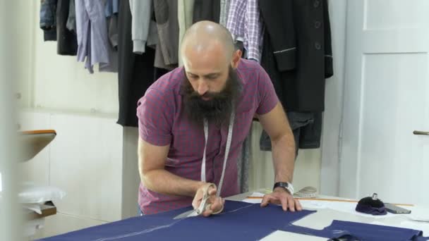 A tailor in a sewing workshop at work. — Stock Video