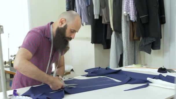 A tailor in a sewing workshop at work. — Stock Video