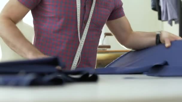 A tailor in a sewing workshop at work. — Stock Video