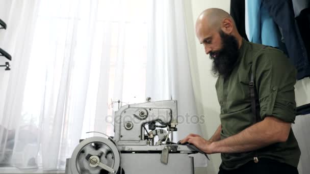 A Tailor works on his eyelet buttonhole machine. — Stock Video