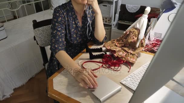 Woman working on the design of the doll using a computer — Stock video