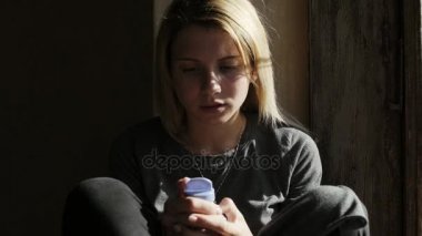 Depresif kız ağlıyor ve hapları tutarak. Yakın çekim