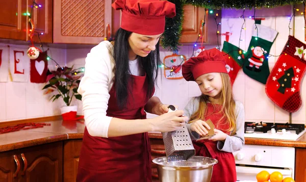 Mother teaches her daughter to work with sugar mastic for decorete cupcakes