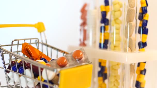 Supermarket trolley filled with medical capsules on a white background — Stock Video