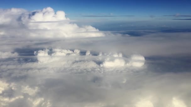 Verbazingwekkende beelden van de lucht boven de wolken. Over de wolken vliegen. Zicht vanuit het vliegtuigraam op de blauwe lucht en witte wolken. Luchtzicht vanuit het vliegtuig. — Stockvideo